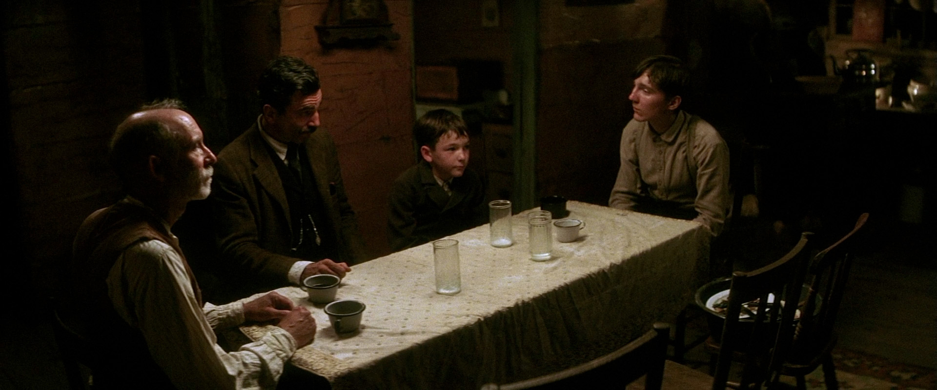 Daniel, H.W., Eli, and Abel sit at the dinner table.