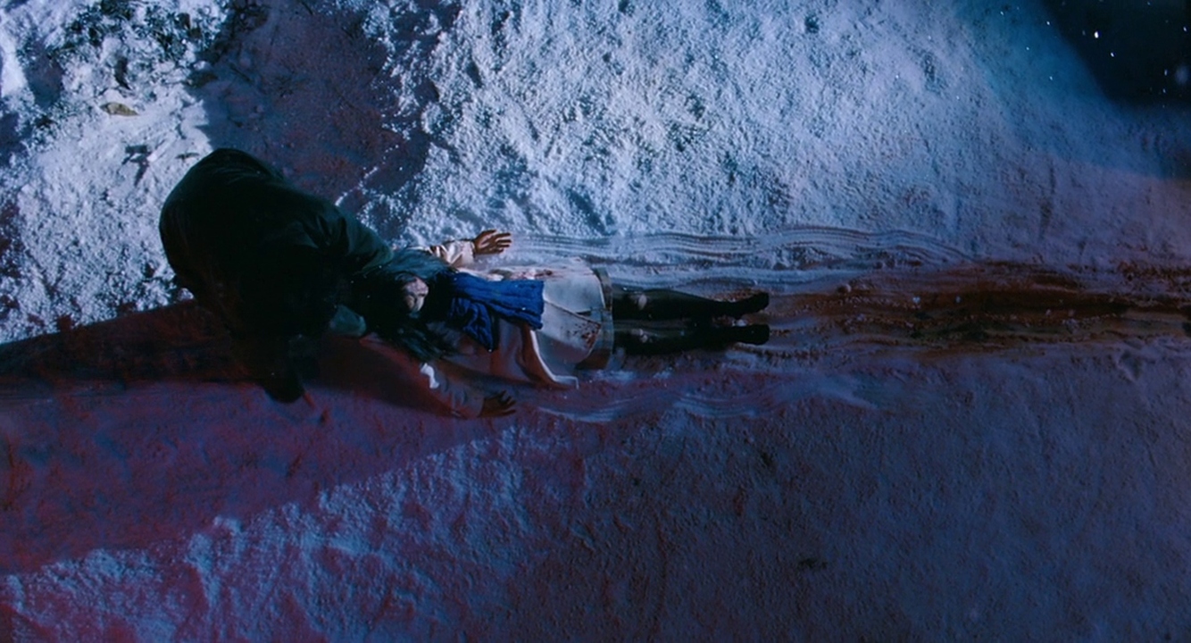 Kyung-chul drags a body through the snow.