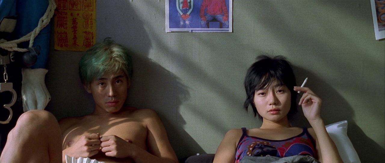 Ryu and Yeong-mi sit in bed against the wall.
